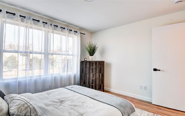 Bedroom with baseboards and wood finished floors | Image 20