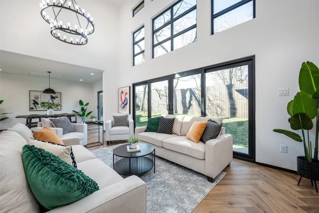 Living area with a towering ceiling and a chandelier | Image 17