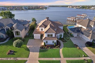 WELCOME TO 3005 S ISLAND, A CUSTOM MEDITERRANEAN HOME SITTING DIRECTLY ON TAYLOR LAKE WITH STUNNING CURB APPEAL COURTESY OF IMMACULATE LANDSCAPING, LANDSCAPE AND SOFFIT LIGHTING. | Image 1