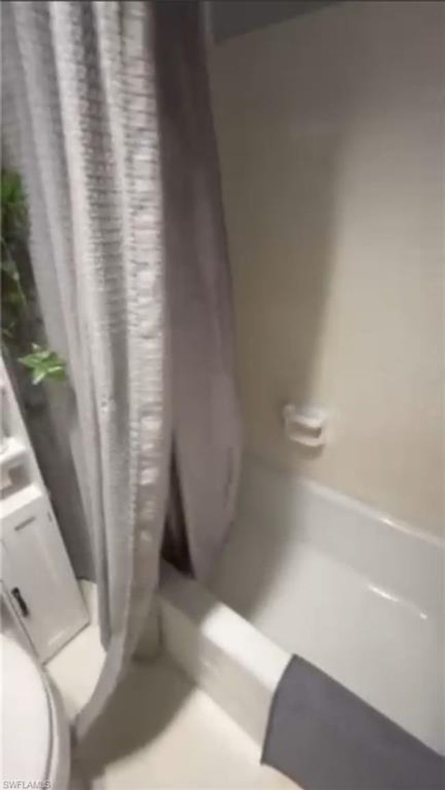 Bathroom featuring shower / bath combo with shower curtain | Image 13