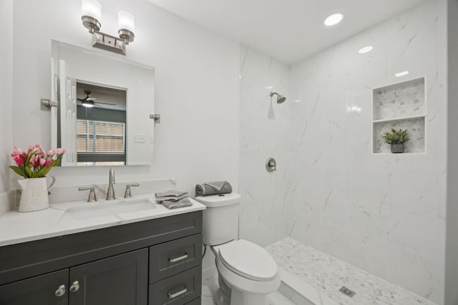 This totally updated Master Ensuite has quartz counters, stylish mirror, faucets and lights - and even a new toilet! The professionally installed shower with designer niches and flooring! | Image 28