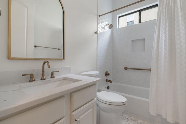 Full bath featuring shower / bath combo, toilet, and vanity | Image 18