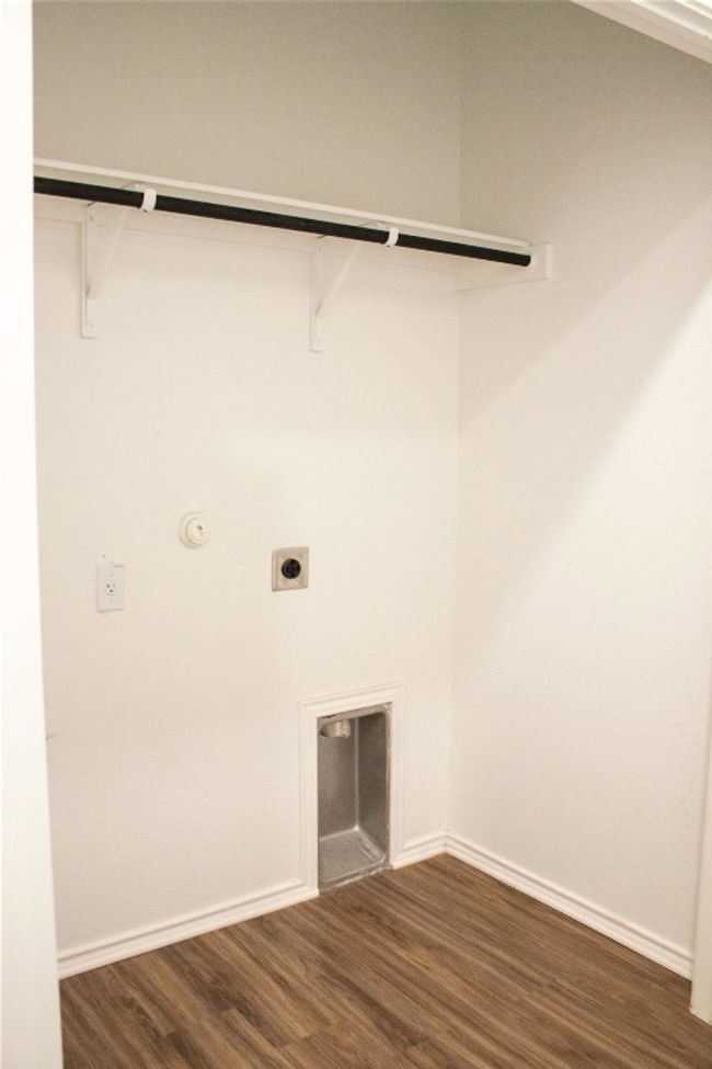 Laundry room with hookup for an electric dryer, dark wood-style flooring, and hookup for a gas dryer | Image 7