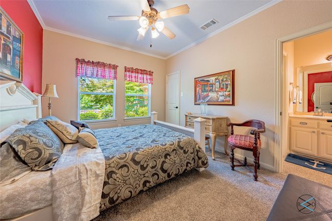 Bedroom featuring crown molding, ensuite bathroom, carpet floors, and ceiling fan | Image 15