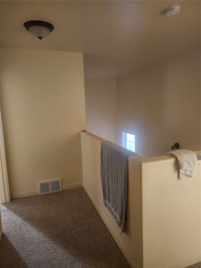 Hallway with visible vents, baseboards, and carpet floors | Image 6