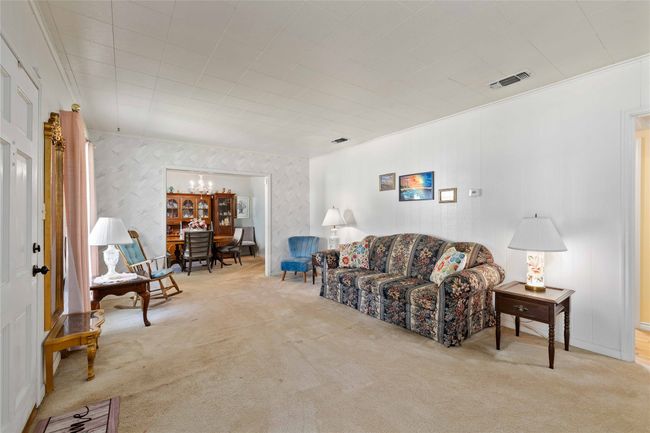 Main living room as you enter from front porch. This view shows formal dining area at the end of the picture. | Image 10