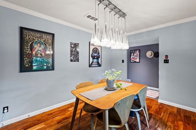 Imagine gatherings in the formal dining room featuring a stunning chandelier! This space flows seamlessly into the well-appointed butler's pantry. | Image 19