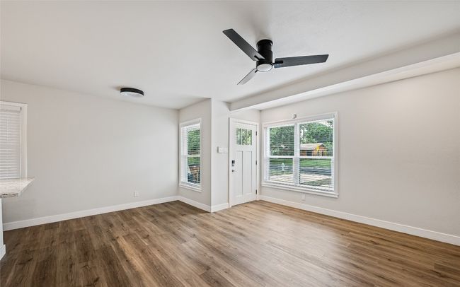Unfurnished room featuring wood finished floors and a ceiling fan | Image 7