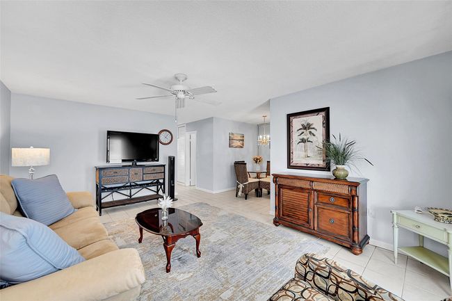 Bright, Open, Spacious and Ready for You and Your Family and Friends to Enjoy! Your Furnished Living Room includes a Queen Sized Sofa Bed, Impact Windows and Doors with Blinds and Retractable Screen Doors! | Image 27