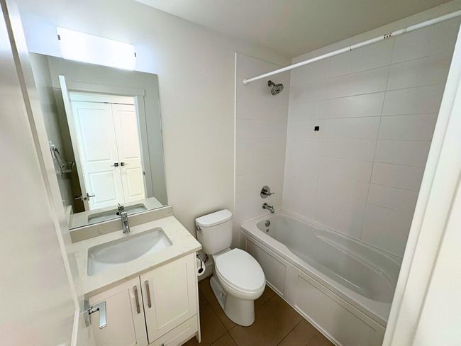 Full bathroom featuring shower / bath combination, vanity, and tile patterned flooring | Image 9