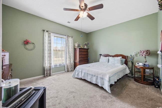 Carpeted bedroom featuring baseboards and a ceiling fan | Image 5