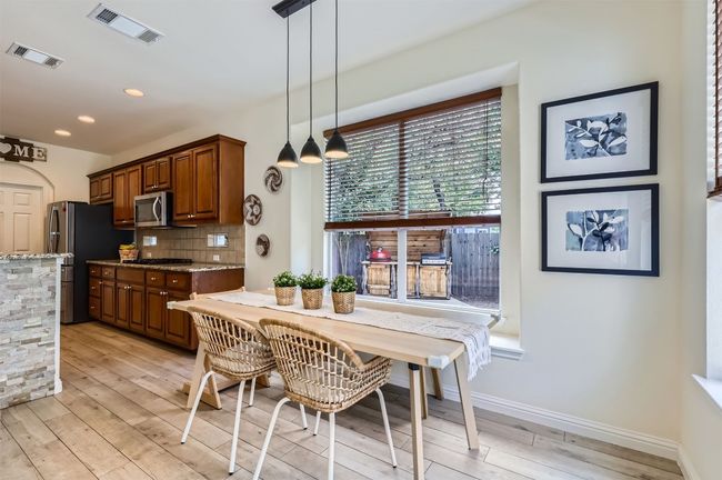 Dining space with large windows framing the outdoor scenery. | Image 13