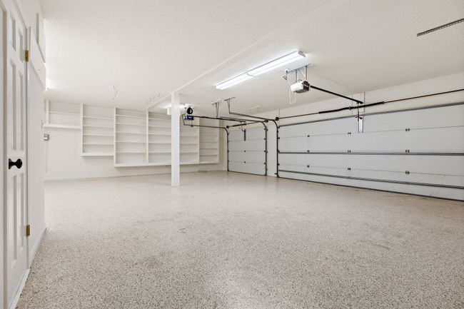 3 car garage w/ epoxy flooring, storage closet, half bath | Image 29