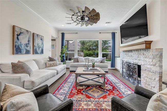 What a statement this living room makes with a completely renovated stacked stone fireplace and new mantle. Tons of light floods into this space. | Image 9