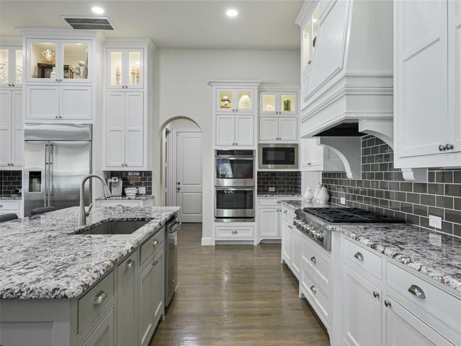 Gas cooktop, Double oven, built-in microwave, built-in refrigerator, stainless steel appliances and 42" lighted wall cabinets | Image 14