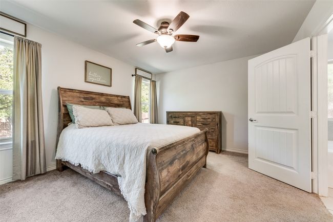 Bedroom featuring light carpet, baseboards, and a ceiling fan | Image 20
