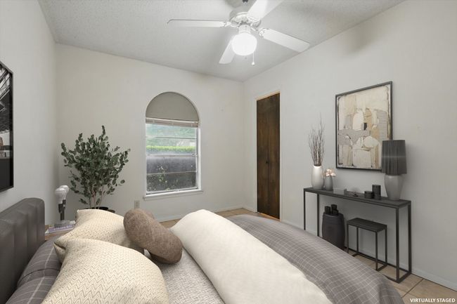Bedroom featuring tile patterned floors and ceiling fan | Image 7