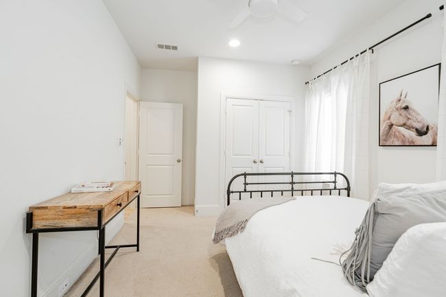 Bedroom featuring a closet, a ceiling fan, and light carpet | Image 33