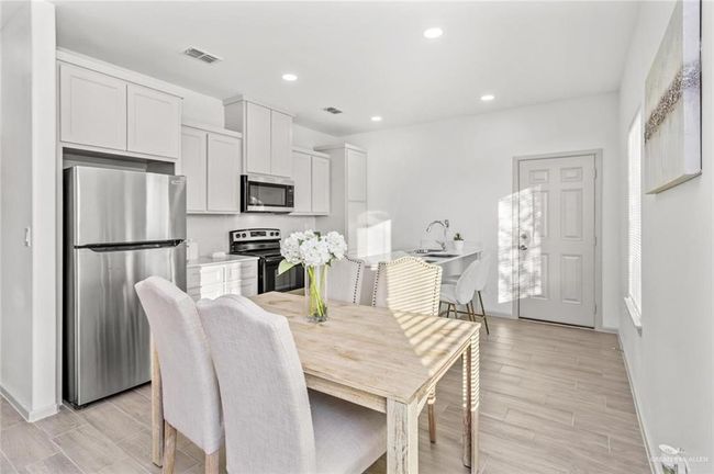 Dining room with recessed lighting and light wood finished floors | Image 4