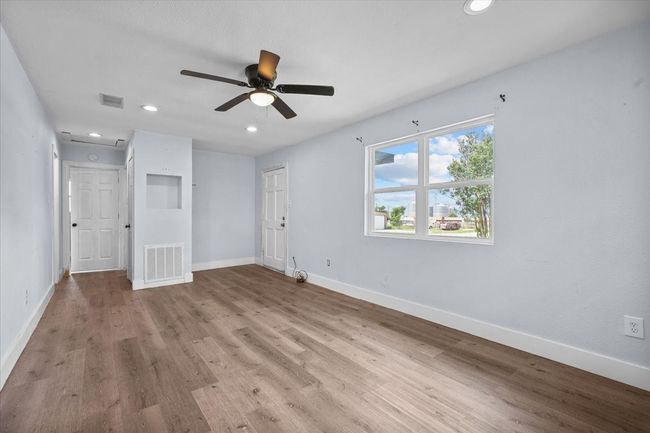 Unfurnished bedroom featuring baseboards, wood finished floors, recessed lighting, and a ceiling fan | Image 5
