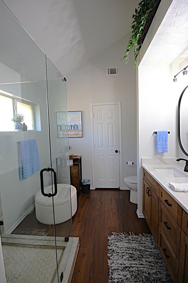 Bathroom featuring double vanity, toilet, a custom shower, and double sink | Image 34