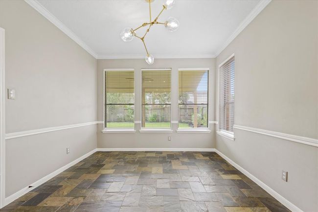 Enjoying meals with loved ones in this stylish dining area overlooking the backyard will be an experience everyone will remember! | Image 6