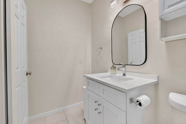 Half bathroom with vanity and tile patterned flooring | Image 20