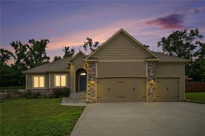 View of front of house featuring a garage and a yard | Image 1