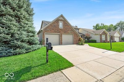 Spacious attached 2 car garage with garage door screen on one door. | Image 3