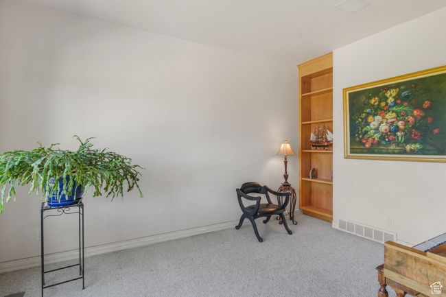 Living area with visible vents, baseboards, built in features, and carpet floors | Image 7