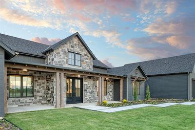 View of front facade with a patio area and a lawn | Image 3