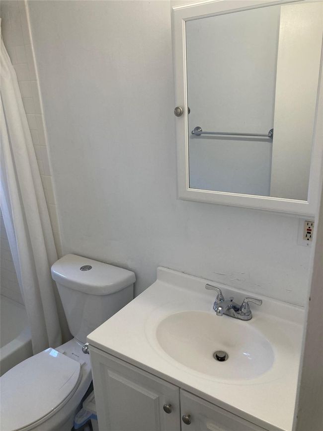 Bathroom featuring shower / tub combo, vanity, and toilet | Image 5