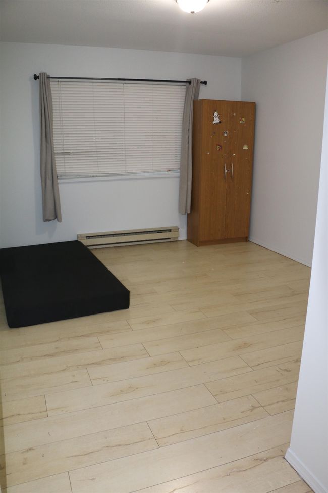 Spare room featuring a baseboard heating unit and wood finished floors | Image 16