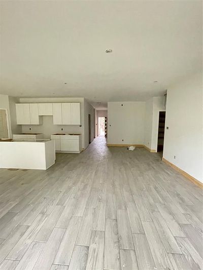 Unfurnished living room featuring light wood-type flooring | Image 3