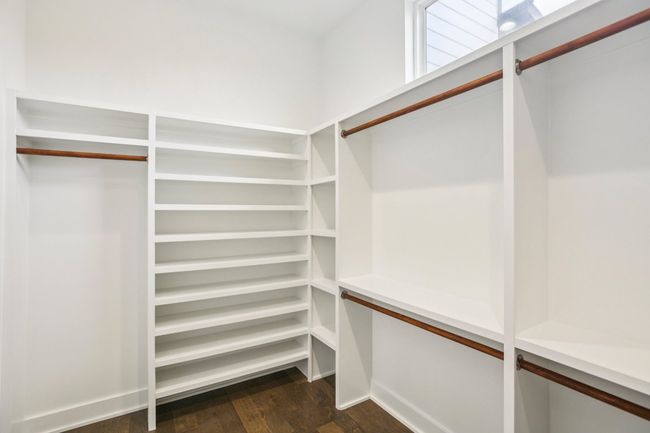 Spacious closet with dark wood-style flooring | Image 23