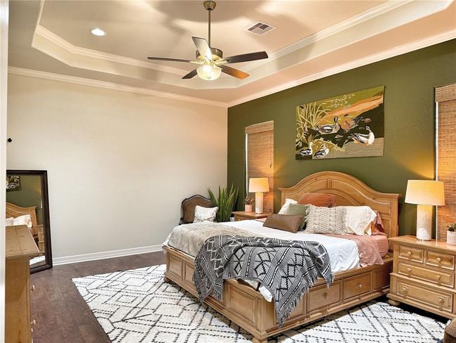 Large Primary bedroom boast coffer ceilings, crown molding and custom blinds | Image 11