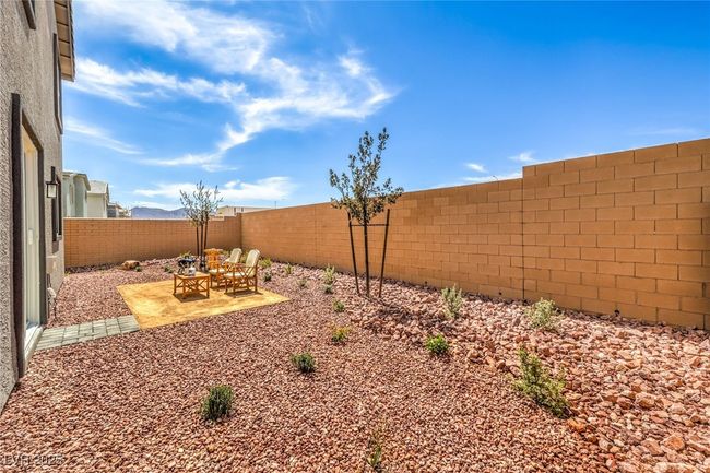Photo is representational only; actual home finishes may vary. Fenced backyard featuring a patio area | Image 40
