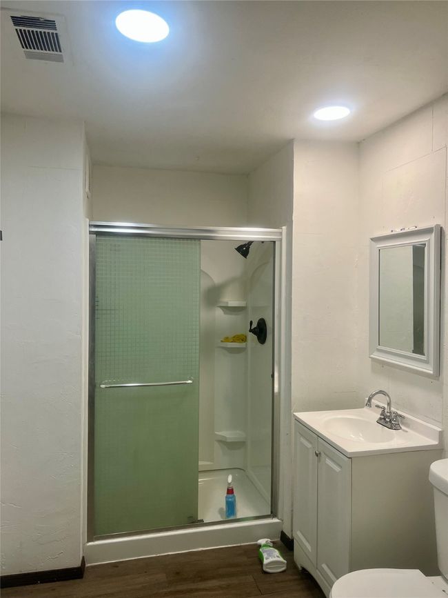 Full bath featuring a stall shower, laminated floors | Image 4