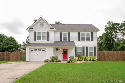 View of front of property with a garage and a front lawn | Image 1