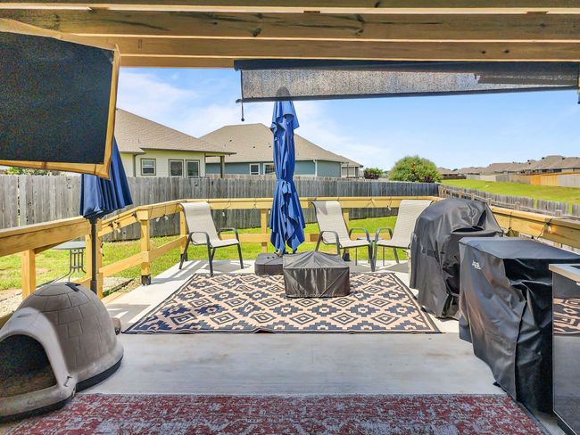 Fenced backyard featuring a fire pit and a patio area | Image 29