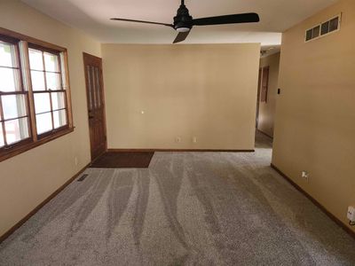 Carpeted empty room with ceiling fan | Image 2