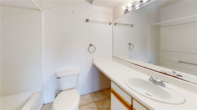 Bathroom featuring toilet, vanity, and tile patterned floors | Image 21