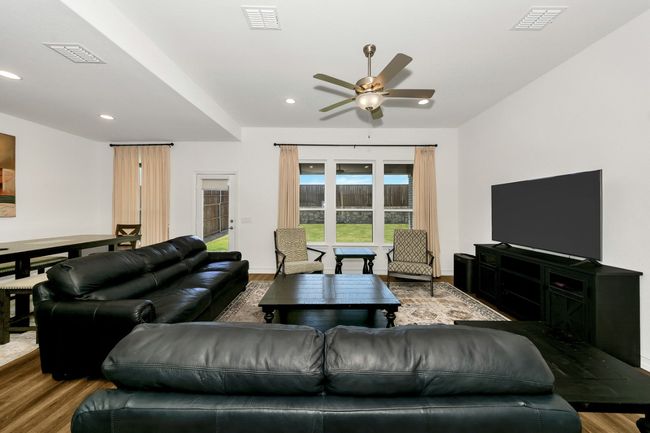 Living area with wood finished floors and visible vents | Image 16