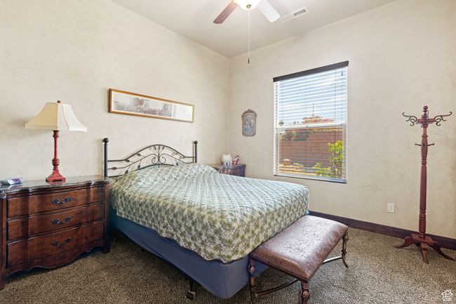 Carpeted bedroom with a ceiling fan | Image 17