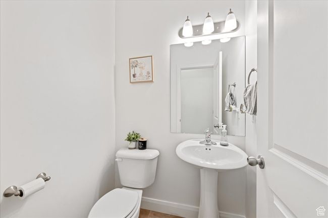 Bathroom featuring toilet and baseboards | Image 14