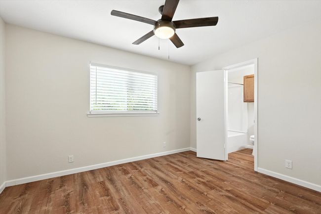 Unfurnished bedroom featuring wood finished floors and ceiling fan | Image 9