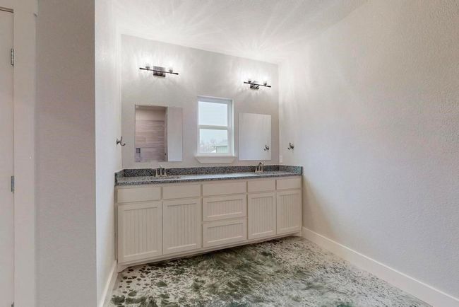 Full bath featuring double vanity, baseboards, and a sink | Image 18