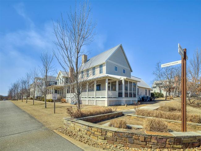 Farmhouse featuring a sunroom, a chimney, and metal roof | Image 38