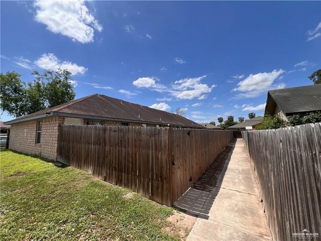 View of side of property with a lawn and fence | Image 10