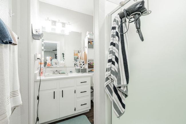 Bathroom featuring vanity and wood-type flooring | Image 8
